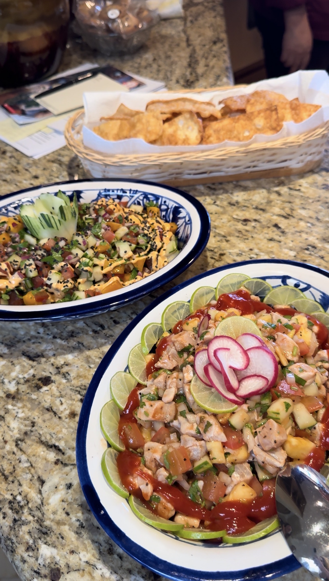 Colorful plated food and a basket of chips on a countertop at Villa La Estancia
