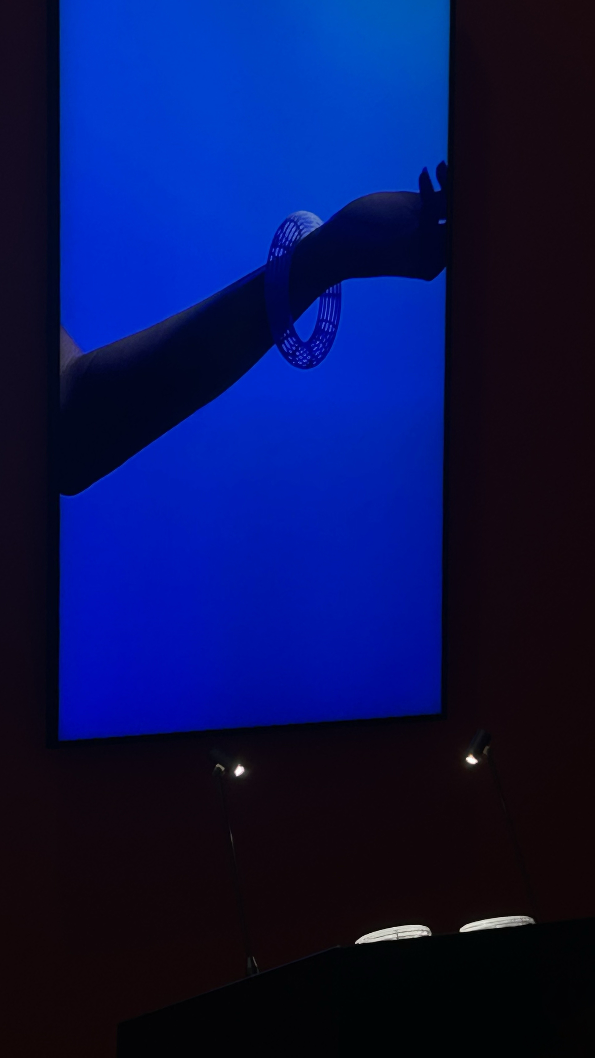 Installation view of the Ceramica Collection presented at Watches & Wonders Geneva 2024 — bracelet displayed on large LED screen.
