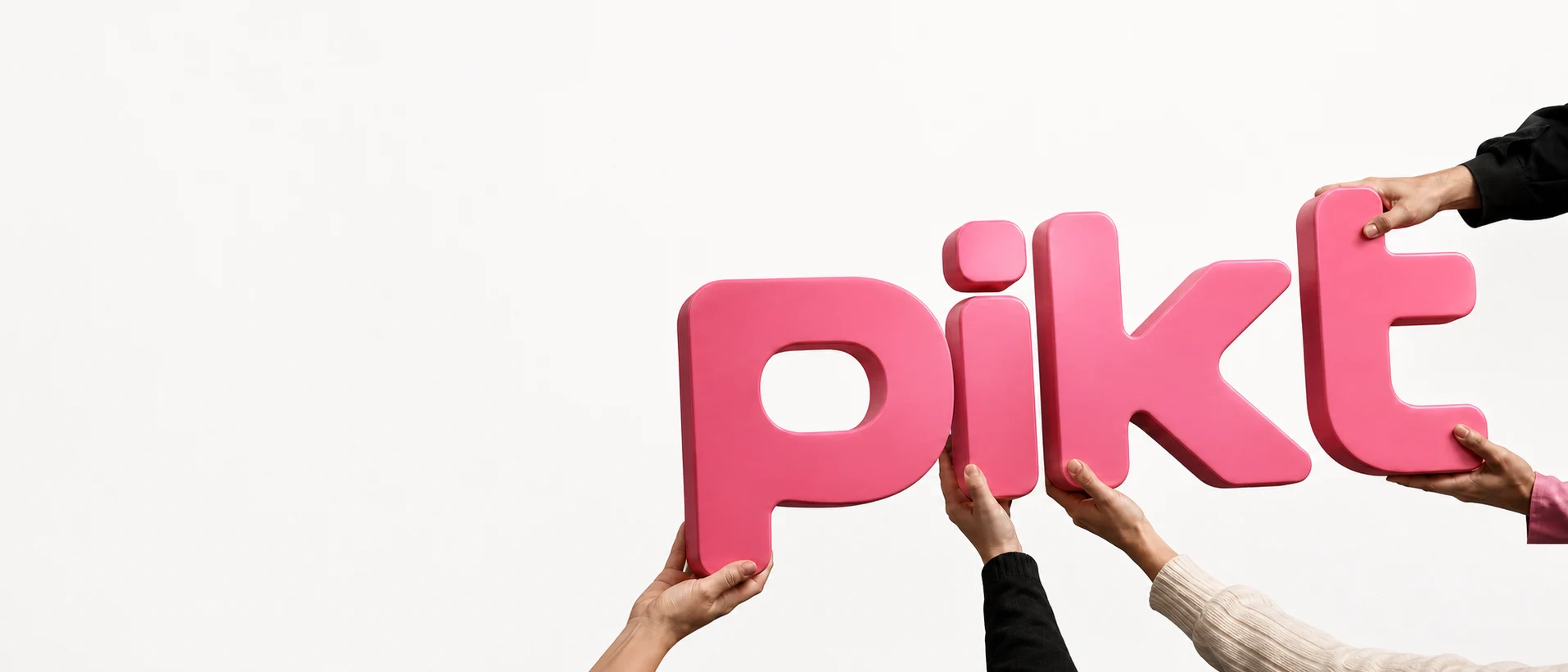 Oversized physical Pikt wordmark held in a white studio