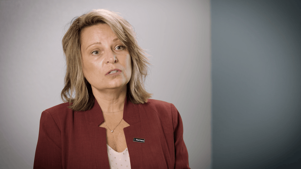 Tanya speaking in a professional setting about AI-powered ophthalmic care