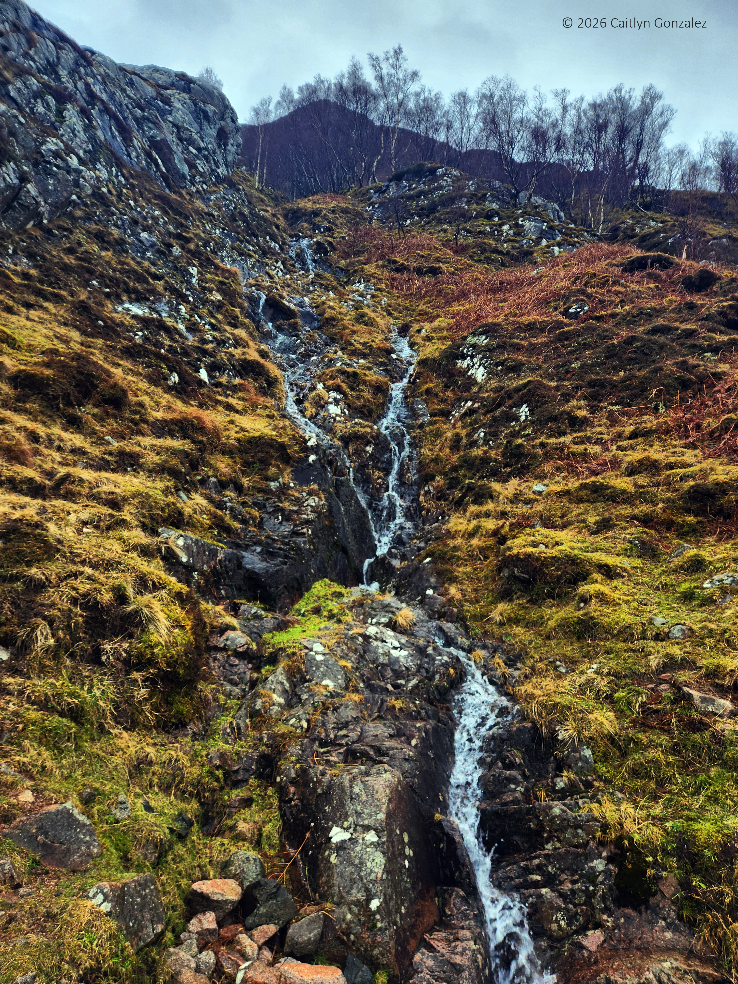 A stream running down the side of a craggy cliff face