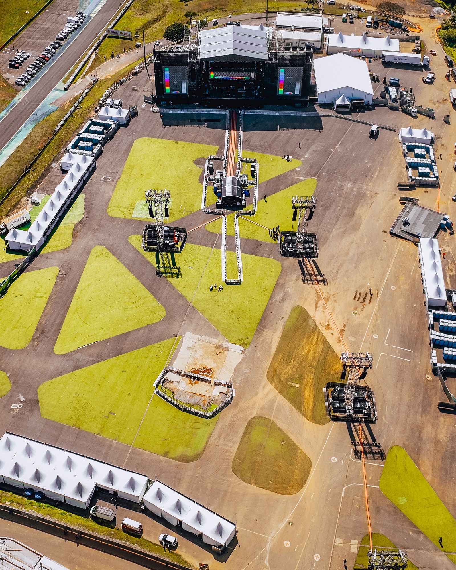 Full outdoor festival production stage with roof, lighting rig, screens and sound towers