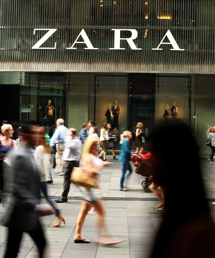 Person in red cap, white shirt, black vest and pants, tan boots.