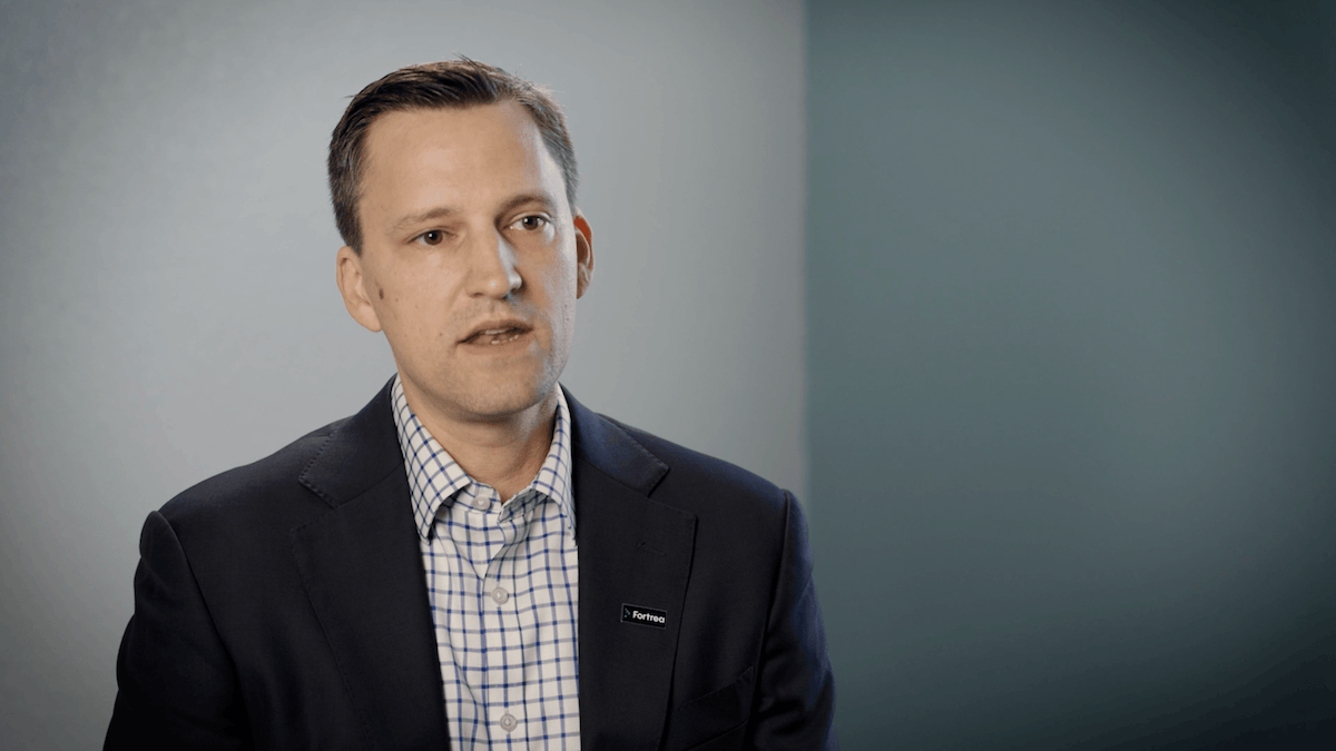 Brian Guthrie speaking in a professional setting about clinical efficiency with Amaros