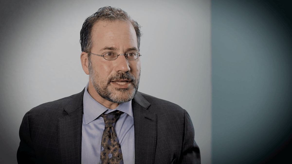 David speaking in a professional setting about real-world evidence and ophthalmic research