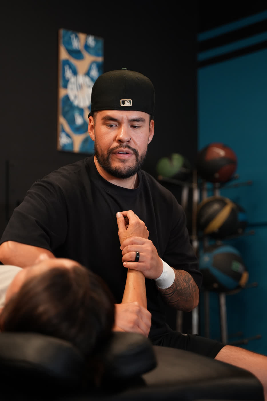 Oscar, owner of AIMS Sports Recovery, working with a client