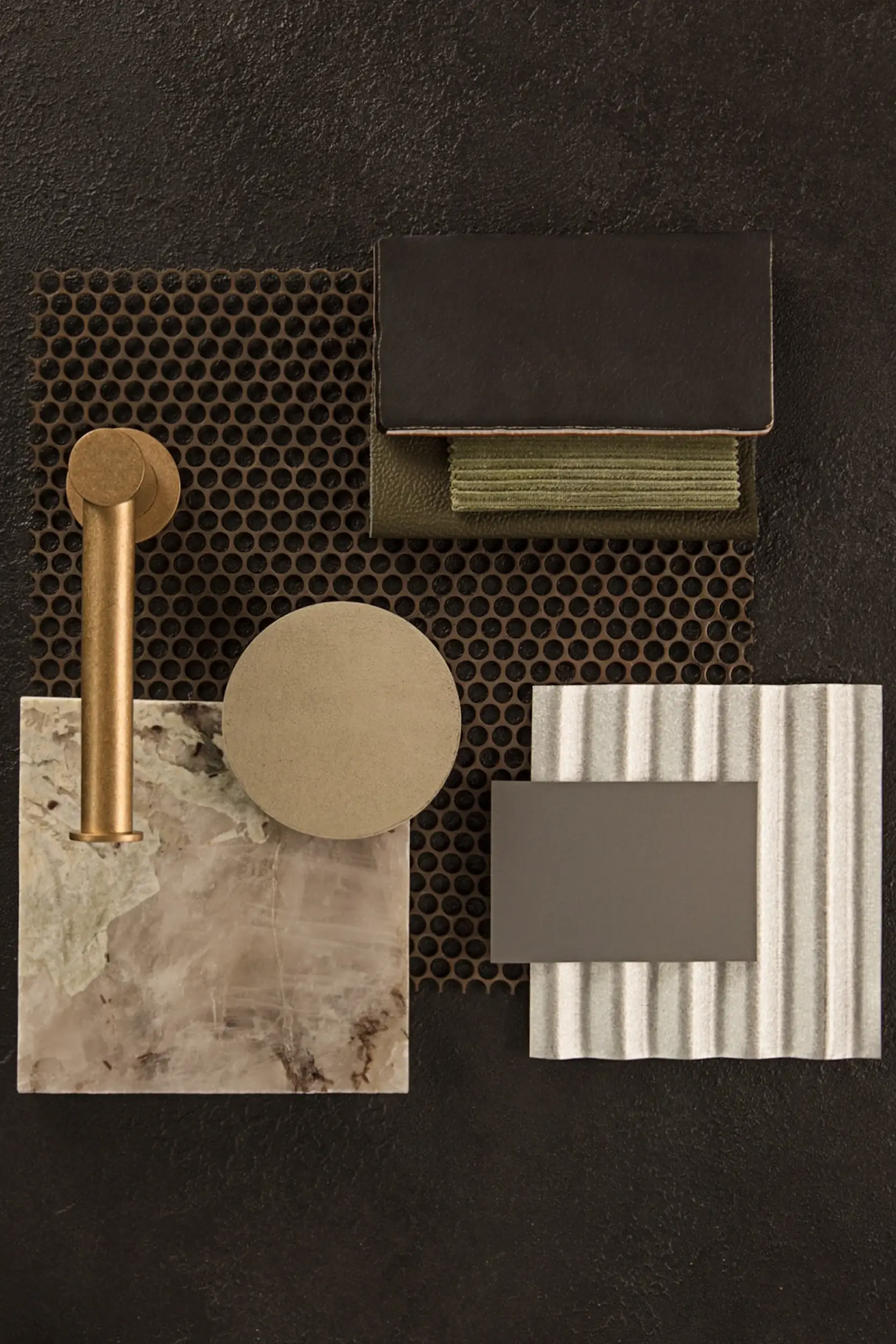 Curated board of mixed materials including metal finishes, fabric swatches, and textured surfaces.