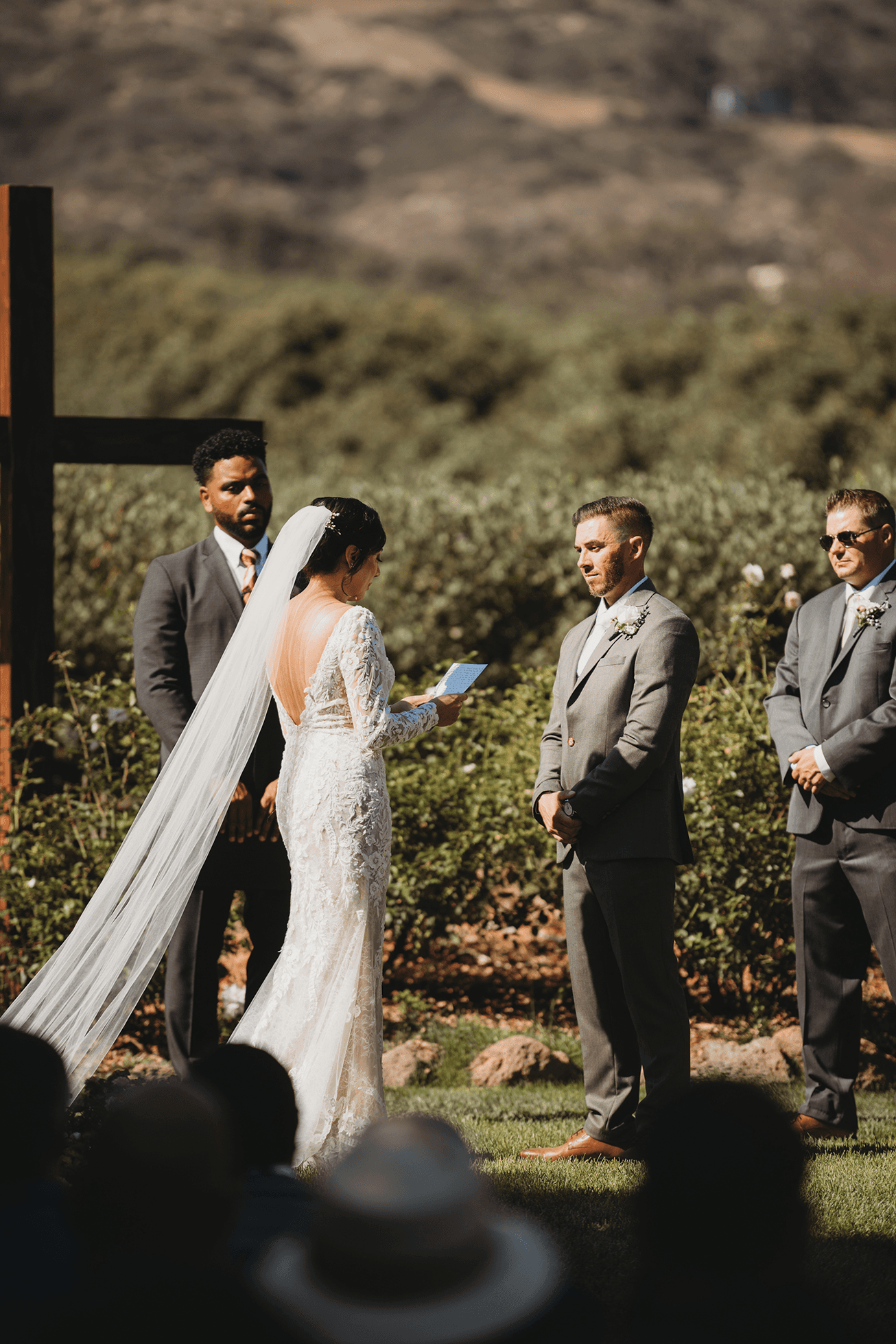 Bride reading vows while groom listens during ceremony