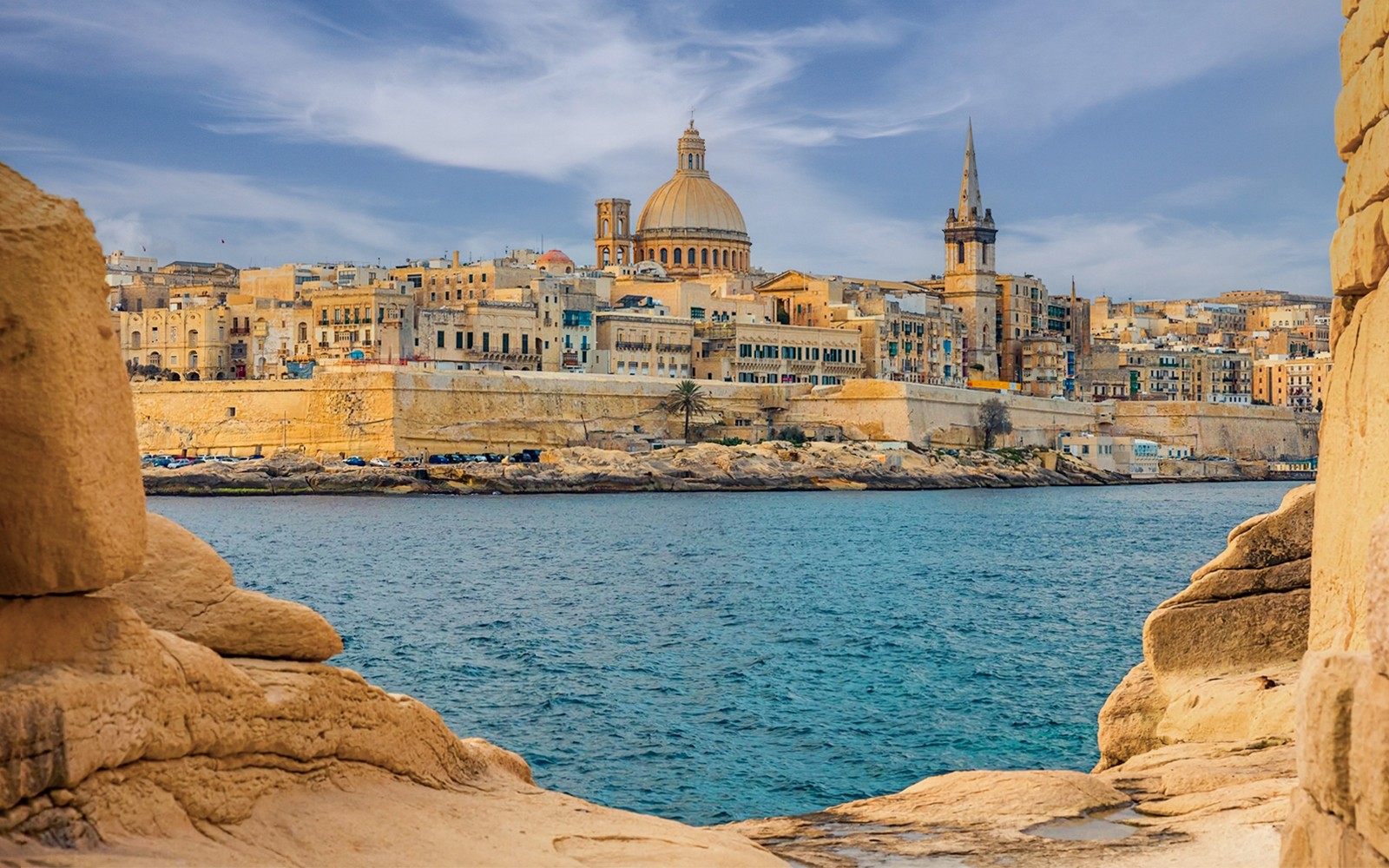 Valletta skyline with dome and spire viewed from the sea, Malta.