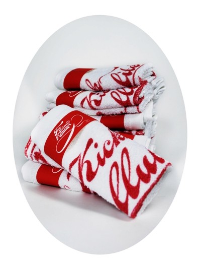 a pile of folded white fabrics with the red message kick cellulite's ass