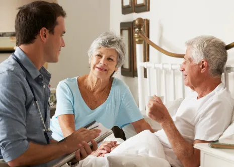 Physician speaking to caretaker and patient.