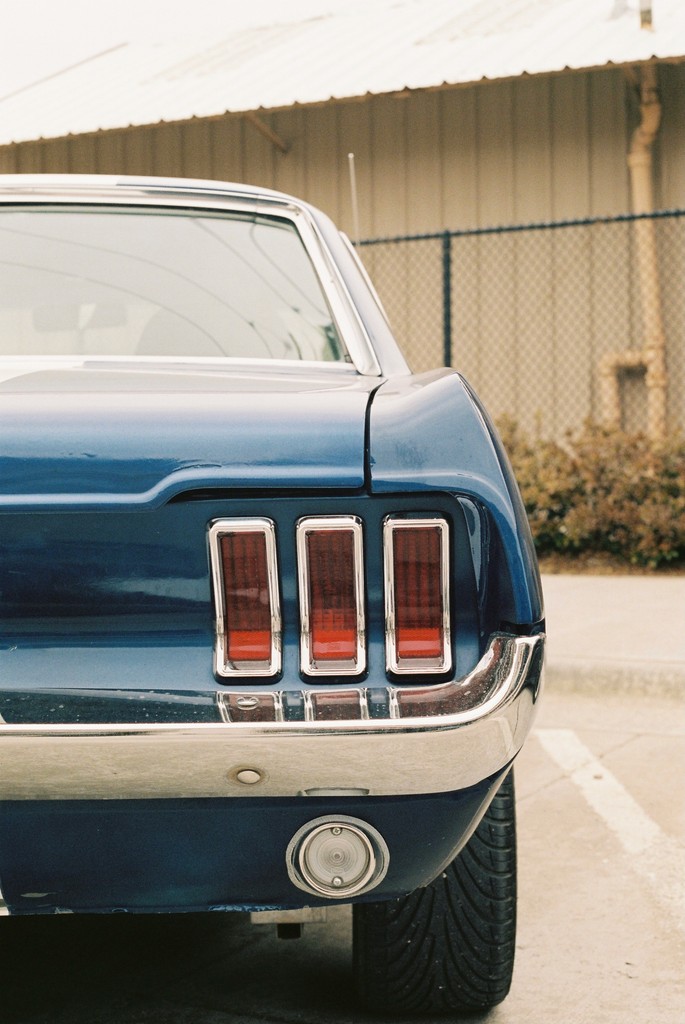 blue car on gray asphalt road during daytime