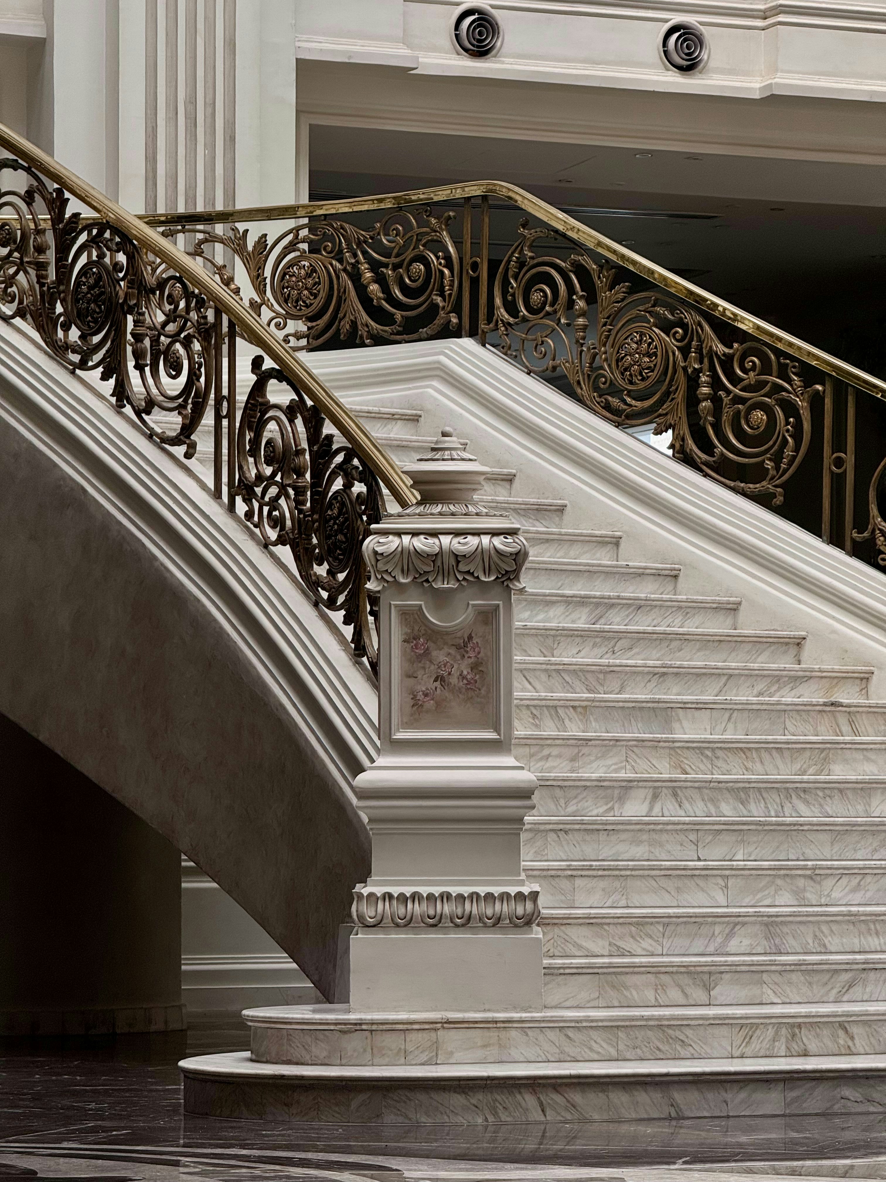 Elegant marble staircase with ornate railings indoors