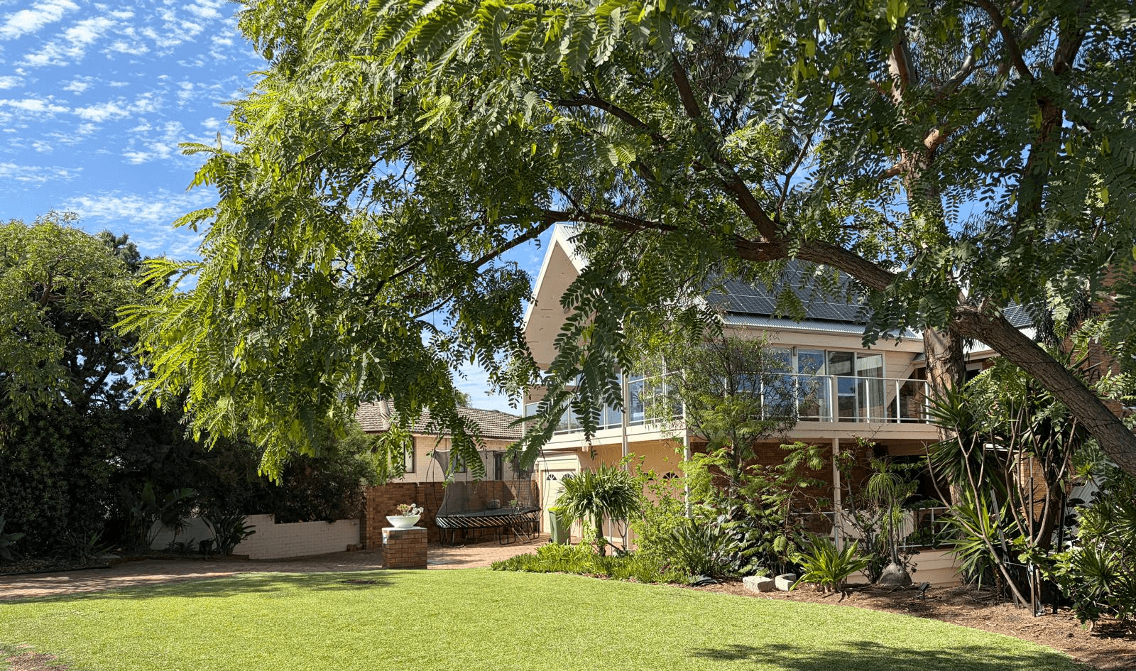 Luxury landscaped garden with precision-trimmed hedge at modern Perth home, showcasing premium residential garden maintenance.