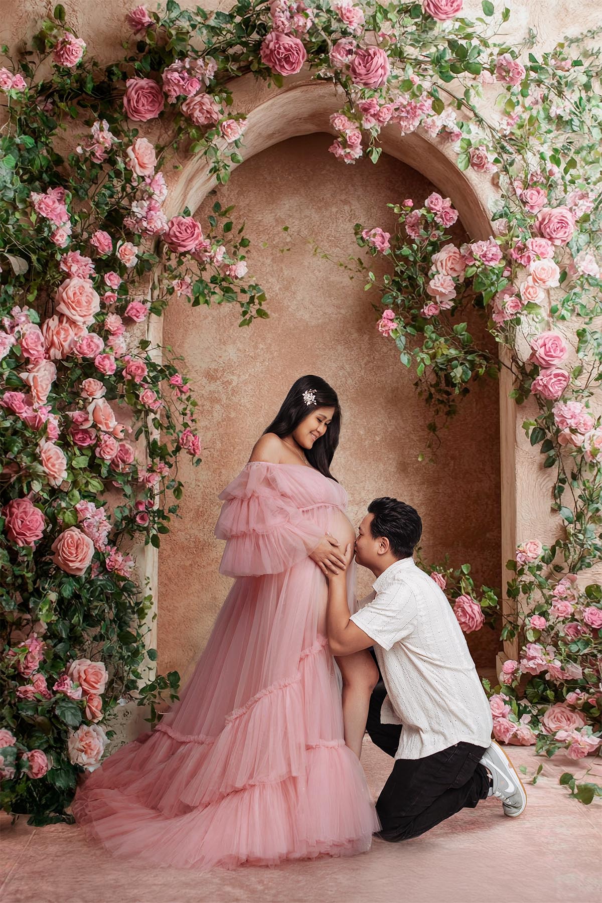 Expecting couple maternity photoshoot — emotional studio portrait.