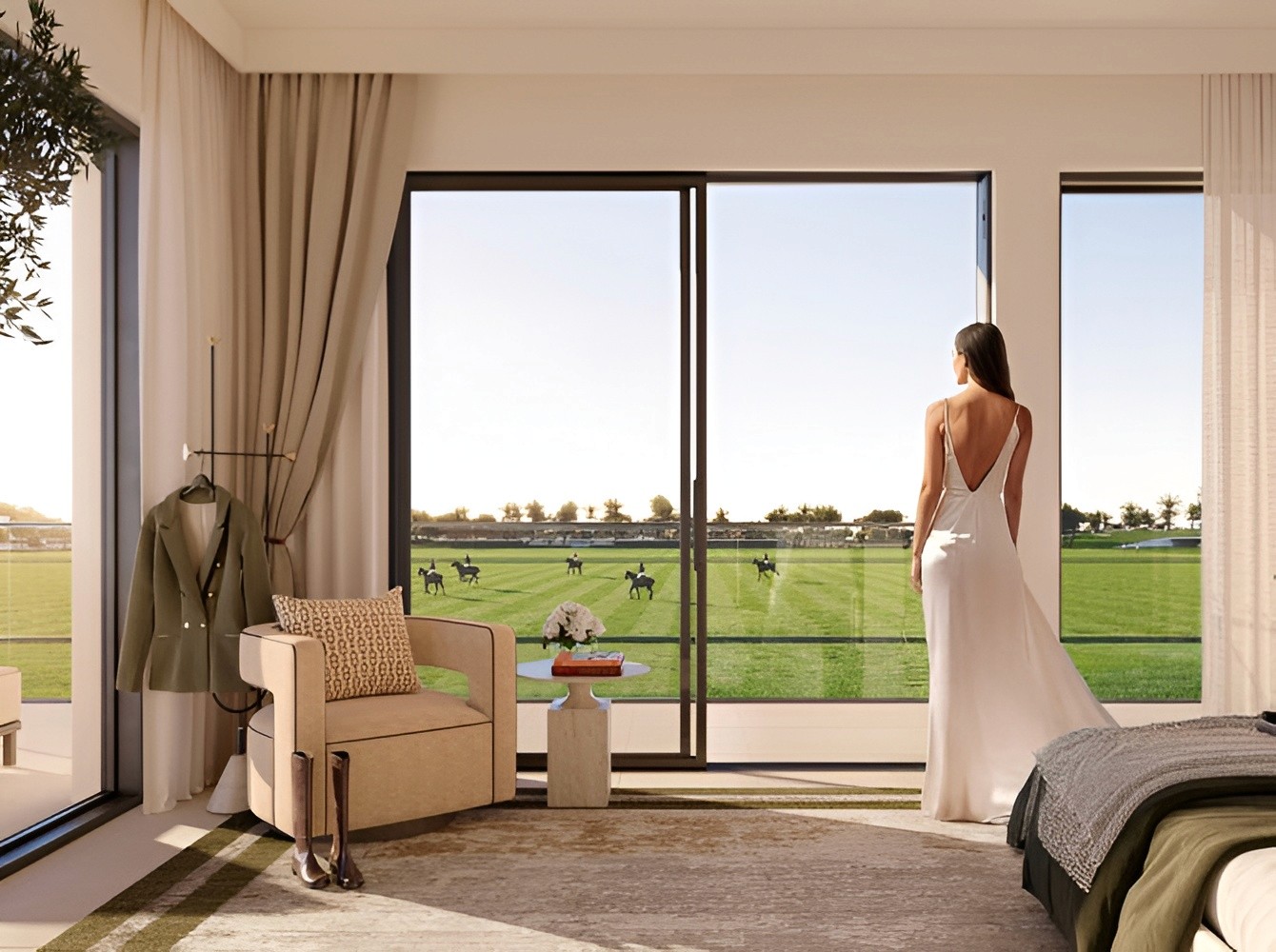 A woman in a white dress gazes out a window at a field, set against the backdrop of Equestra at Grand Polo.