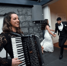 Lucy performing her accordion at a wedding.