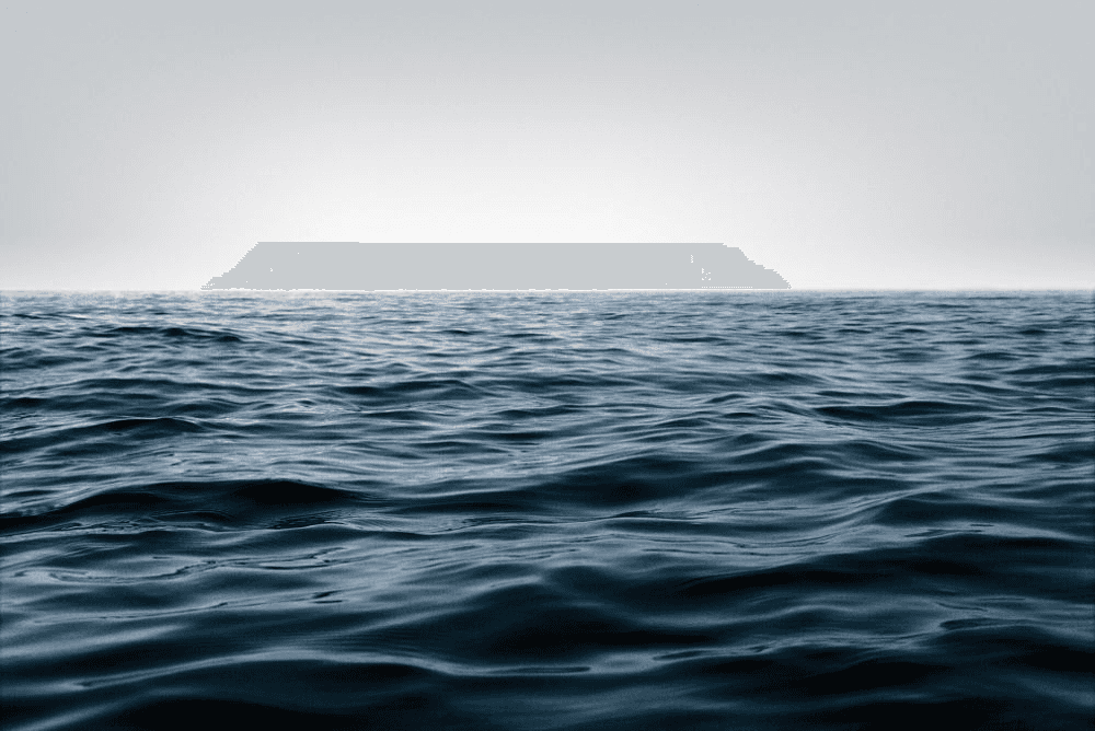Wide view of open ocean water with gentle surface waves under a pale sky, representing water as a natural resource rather than something embedded in pet food packaging
