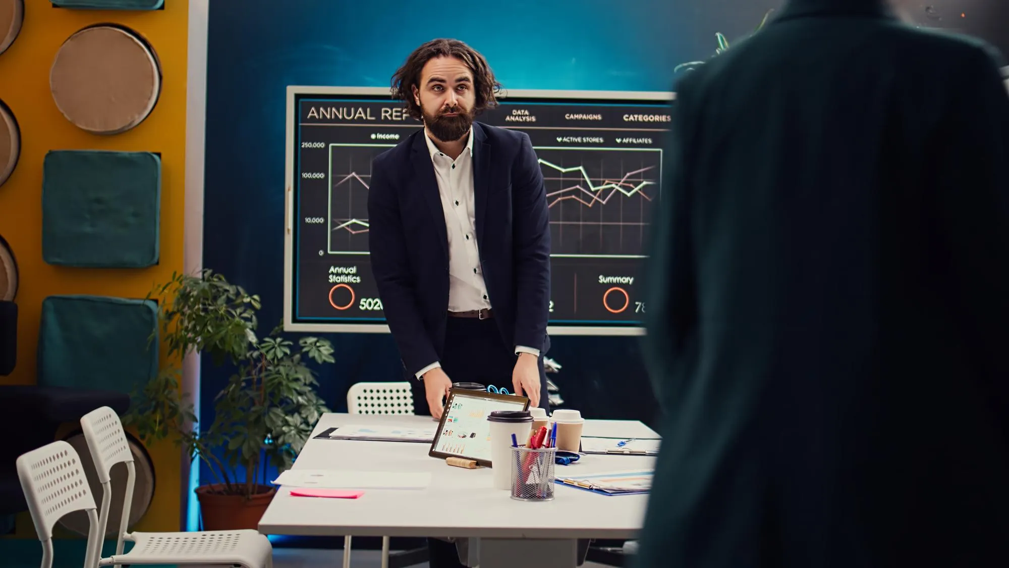Businessman presenting an annual report on a screen in office