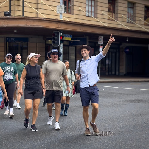 Local guide pointing out buildings in Brisbane