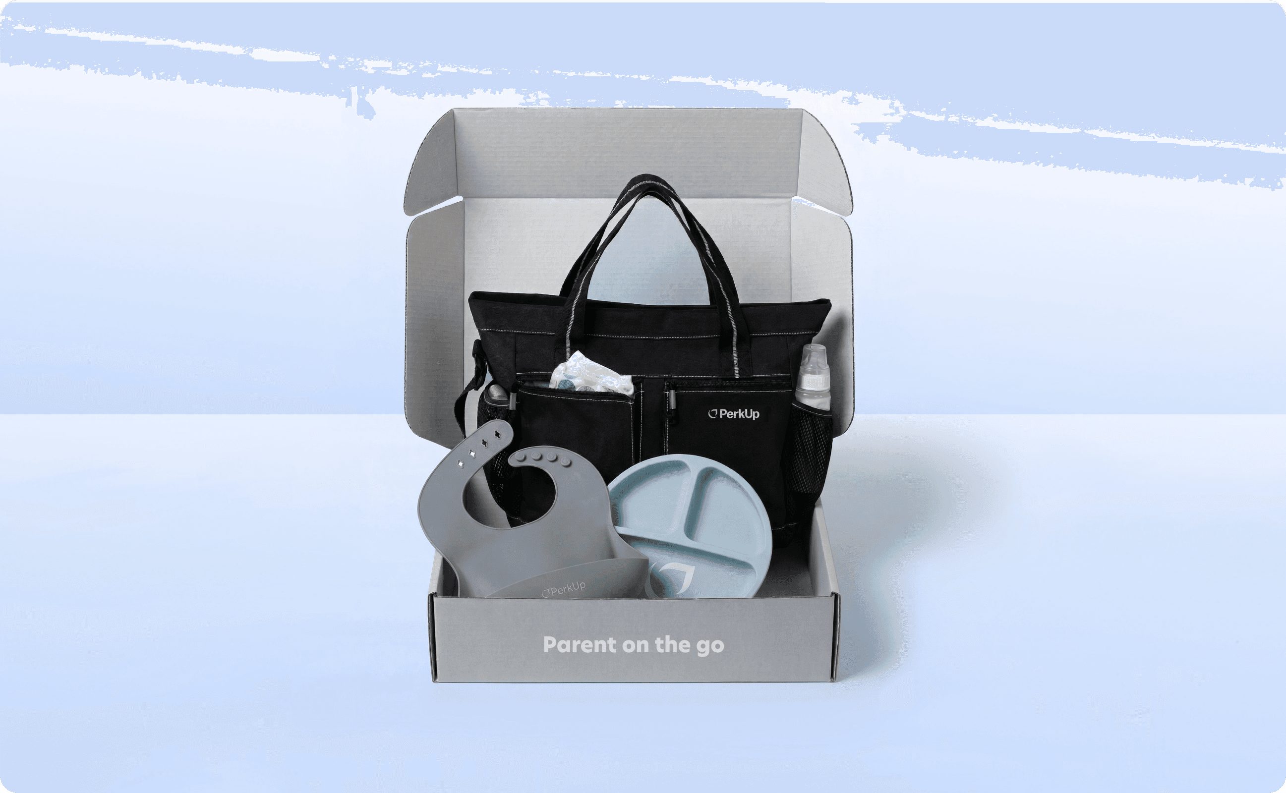 A swag kit with bib, diaper bag, and plate for babies.