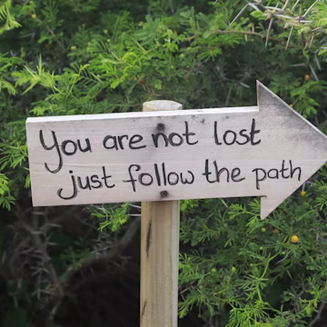 Wooden sign with inspirational message in the woods