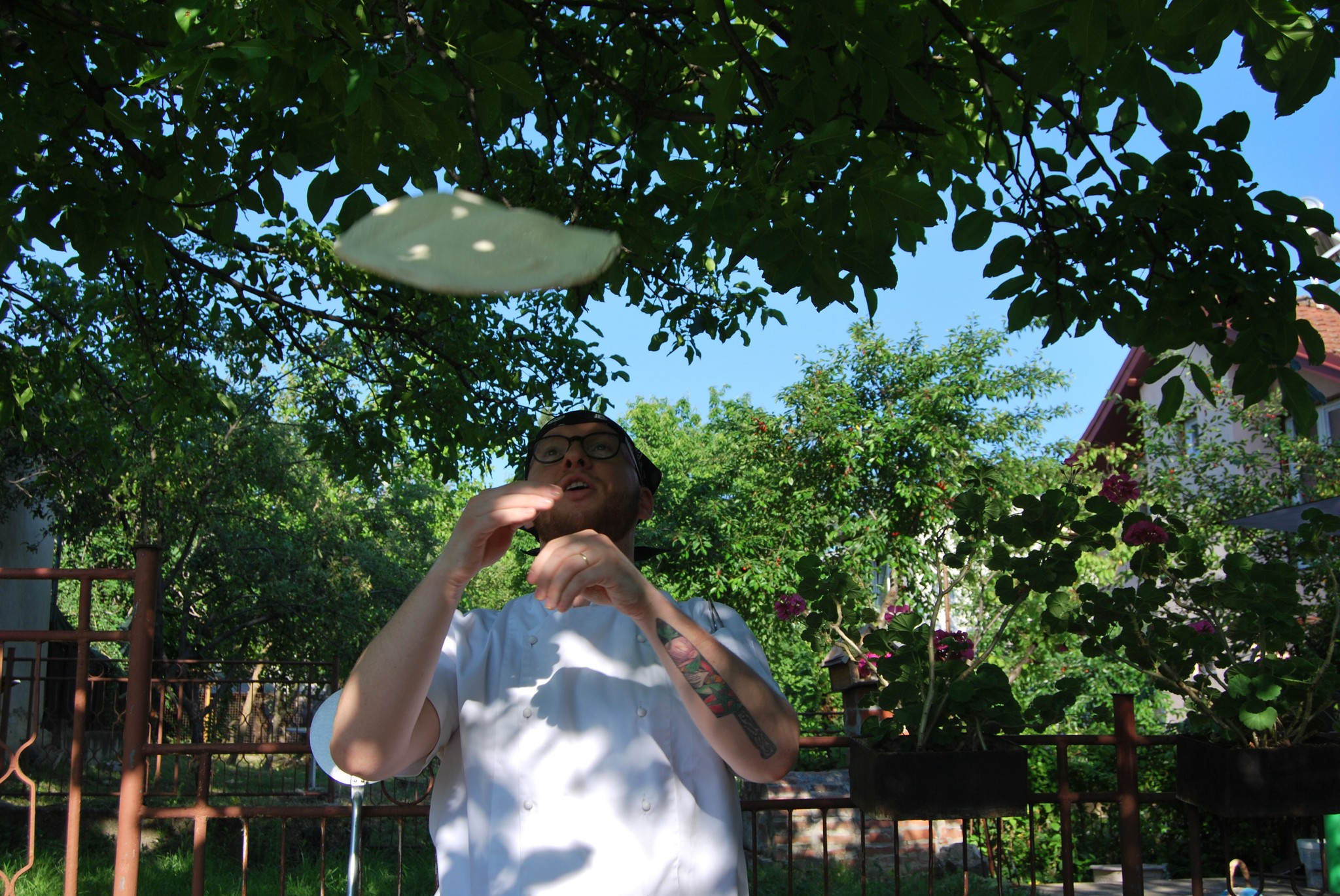Pizza chef tosing dough in the air