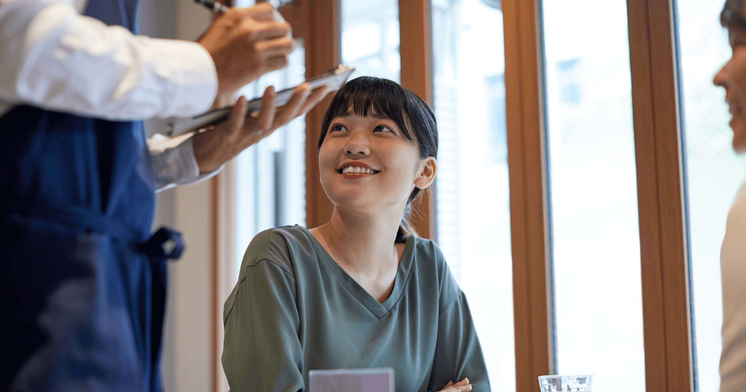 Malaysian customers talking to the waiter about their orders