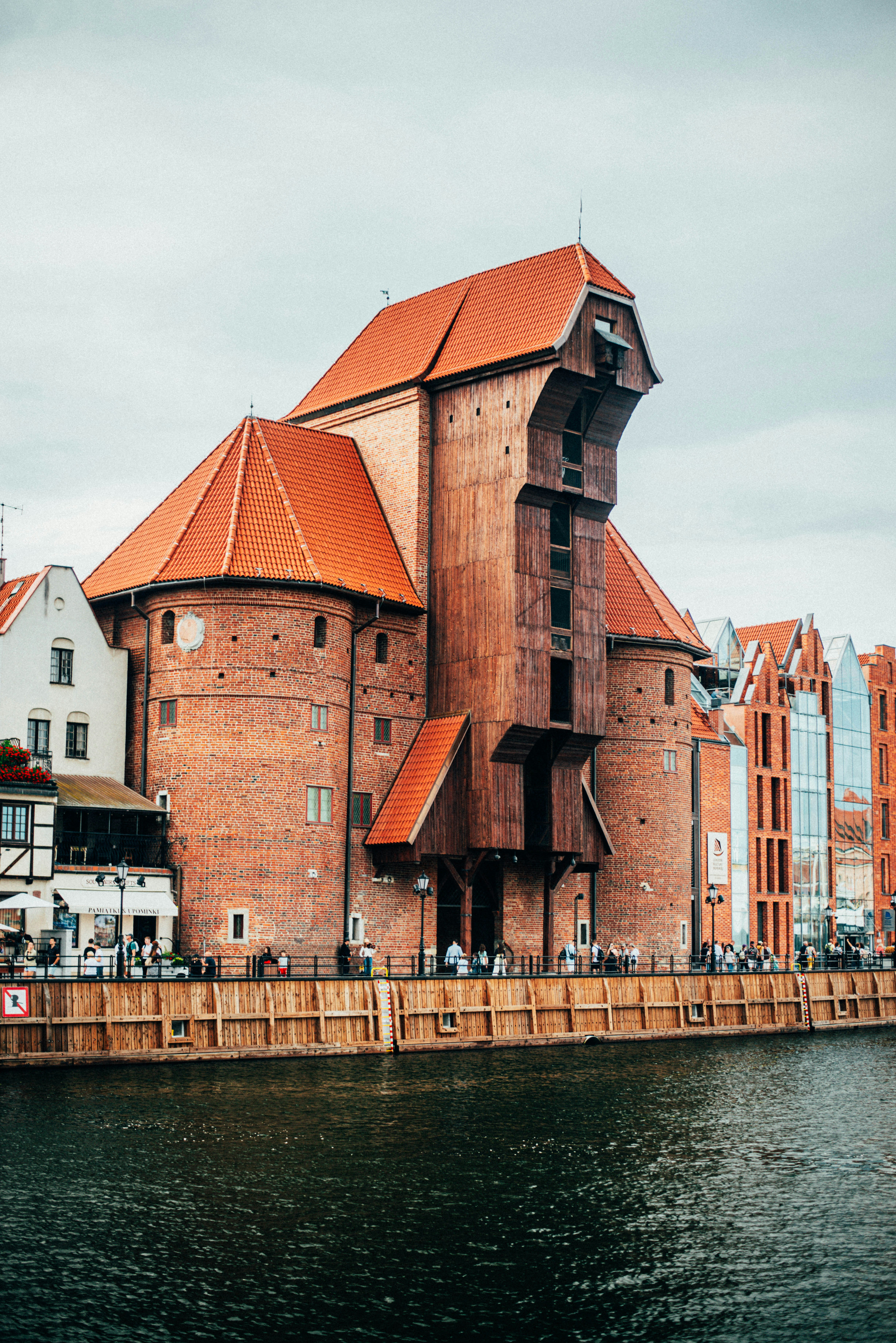 An old brick building stands next to the water.