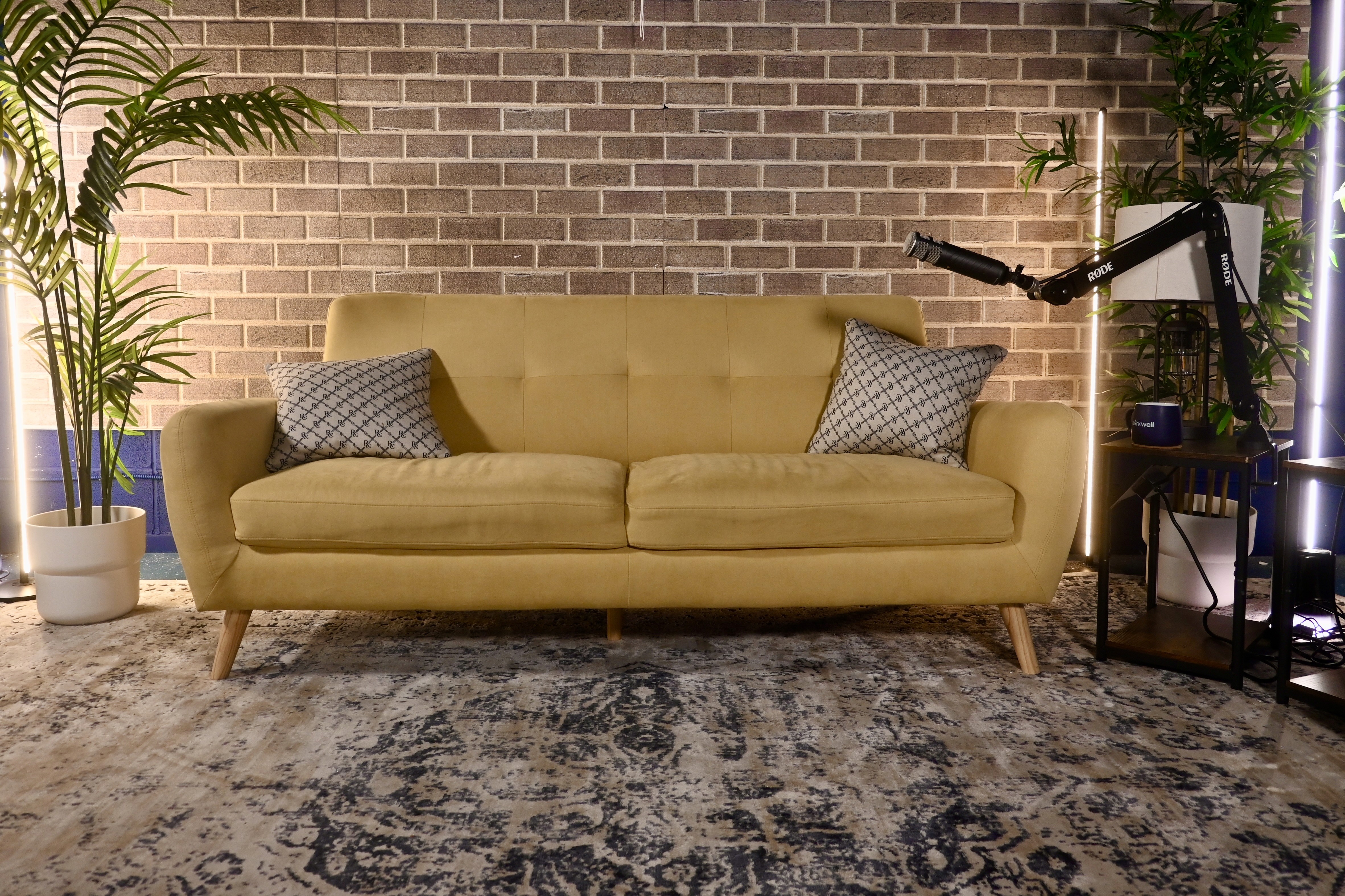 a yellow couch in a podcast studio