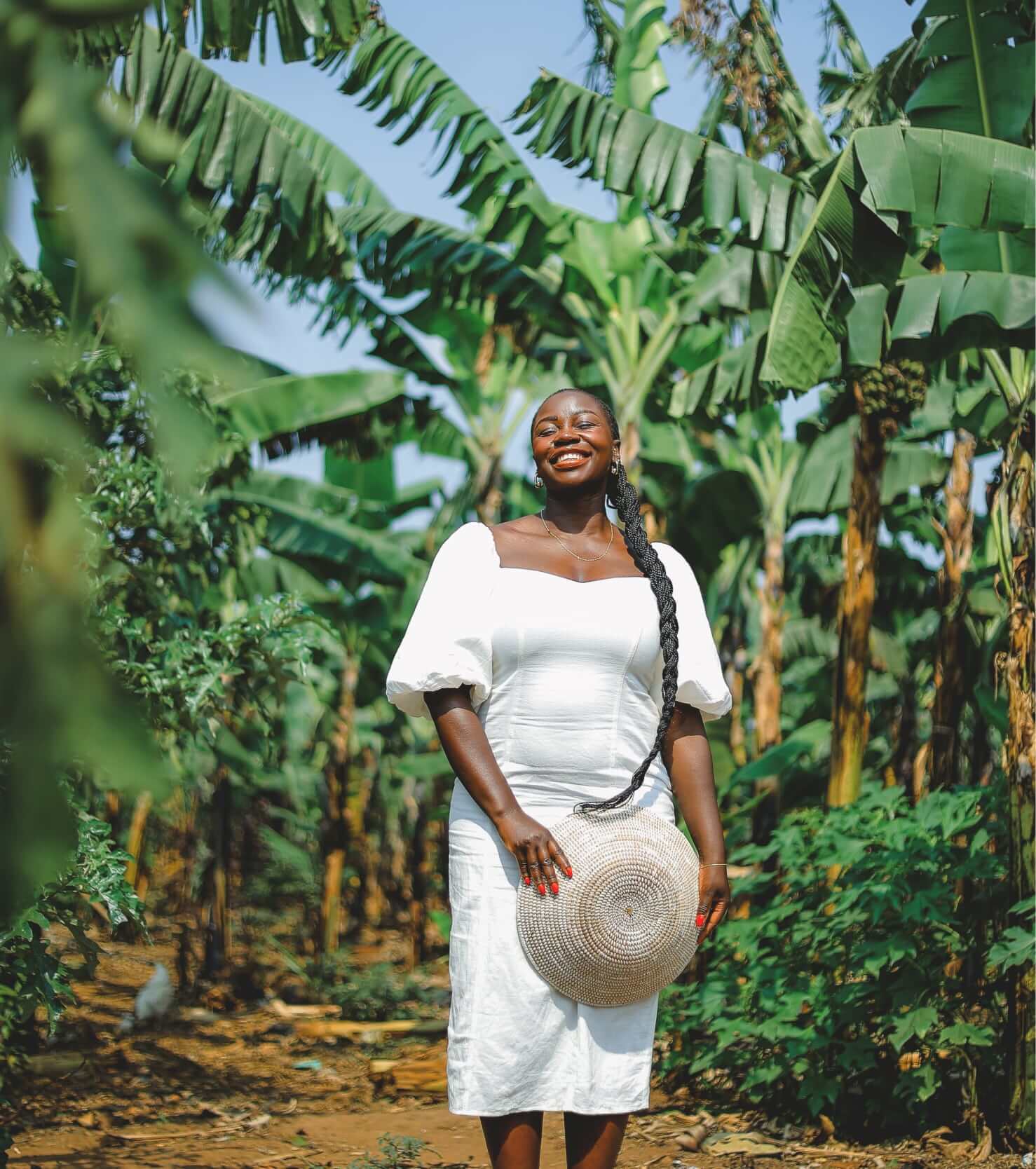 Mary Consolata Namagambe enjoying the sunshine and palm trees in a tropical location in Africa