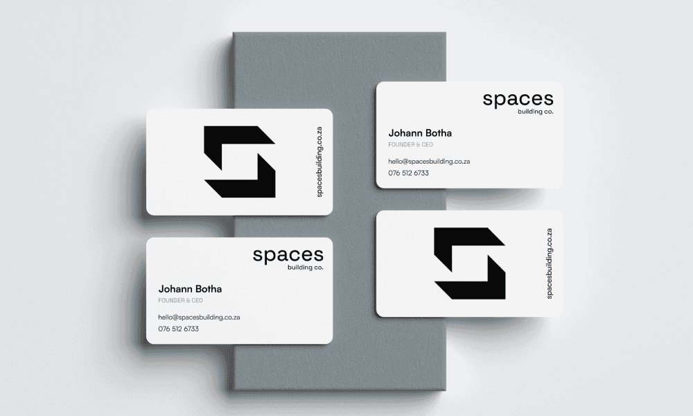 Business cards displayed on a grey block.