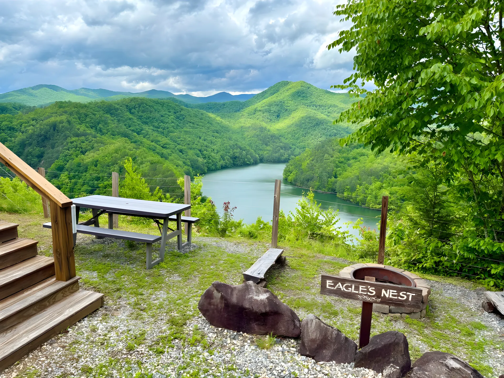 Eagles Nest sign and fire pit above Fontana Lake in summer green