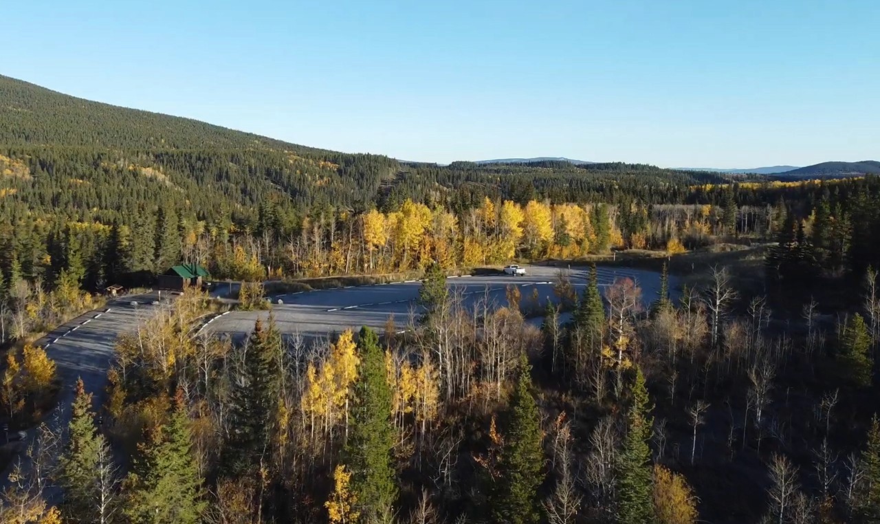 Elevated view of Barrier Dam day use area expansion with parking and facilities along Barrier Lake in autumn