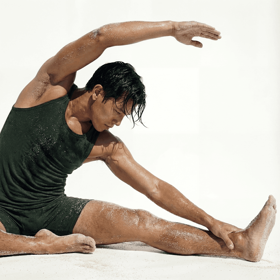 A man doing seated side stretch Targeting tight hips and stiff shoulders through dedicated mobility and deep stretching routines.