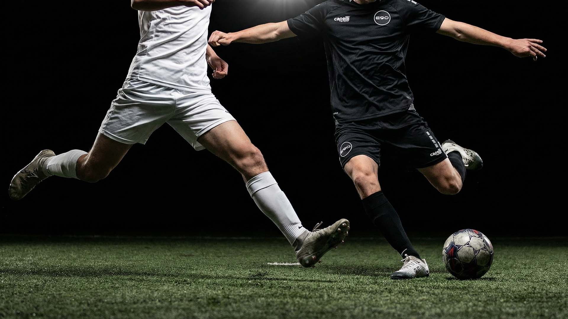 group of people playing soccer on field during daytime