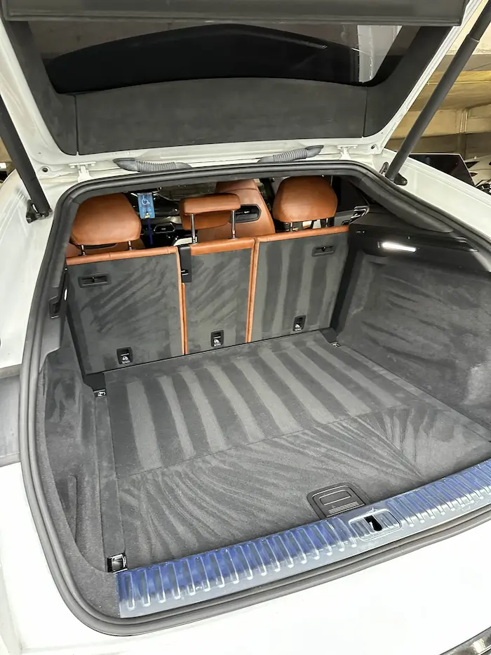 Cleaned vehicle trunk and floor mats with striped pattern.
