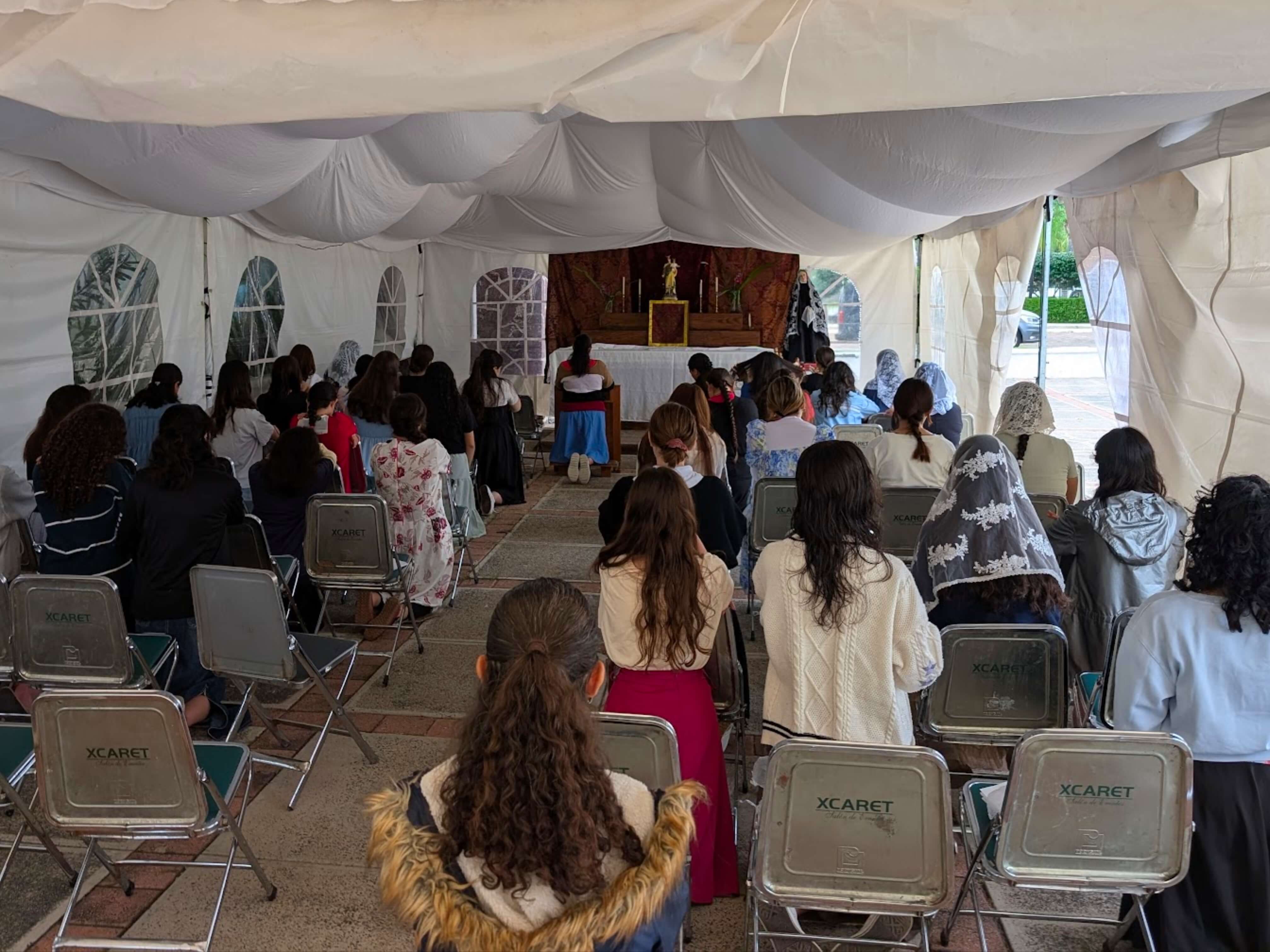 a group of children sitting on steps in front of a building