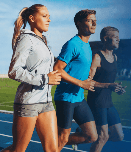 Group of people jogging alongside each other on a race track