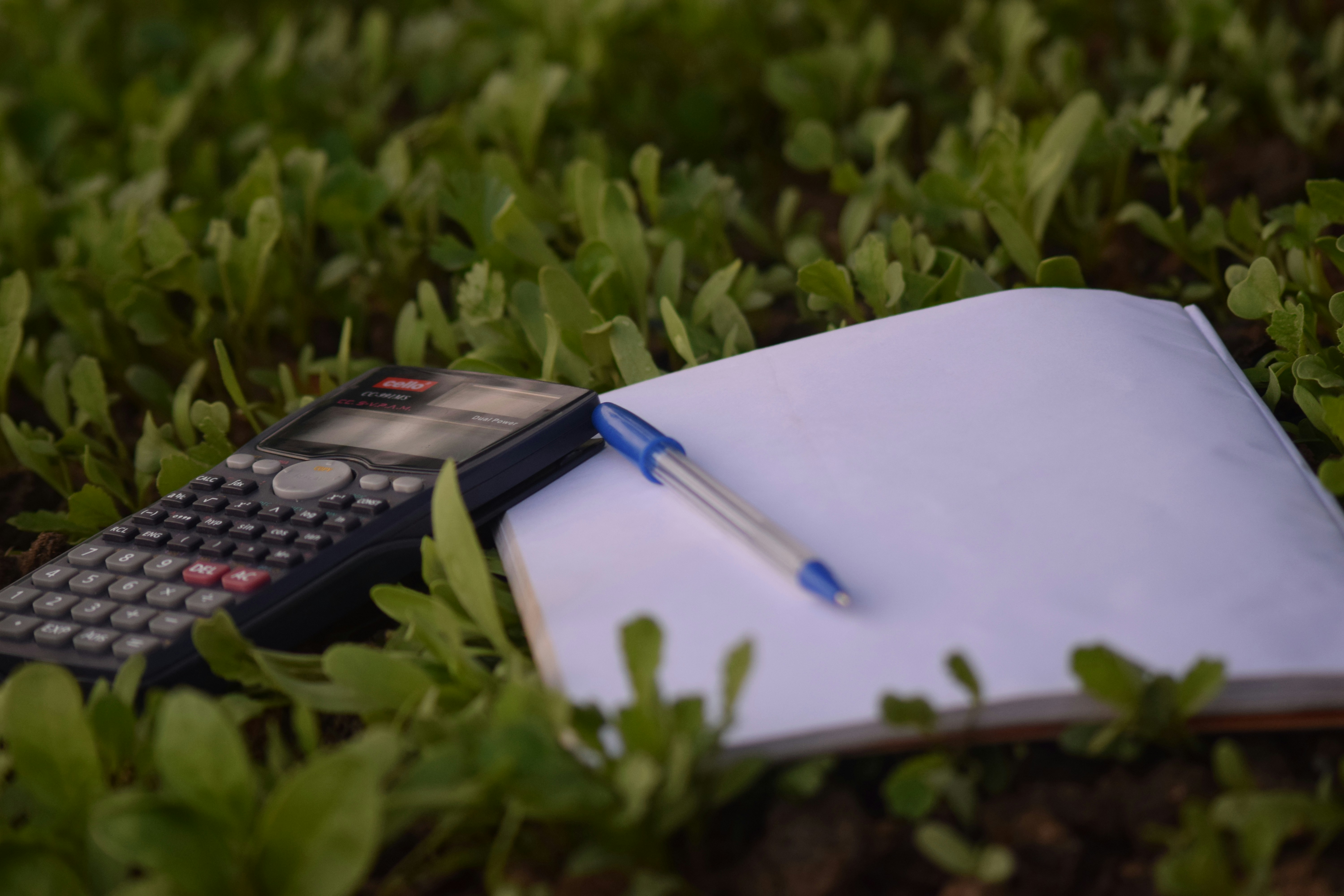 book and calculator in garden - Active Study Methods