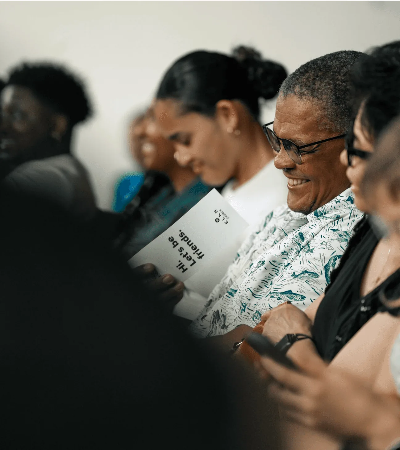 Guests reading a welcome card during a service