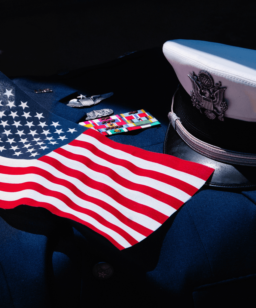 an american flag laying on top of a uniform