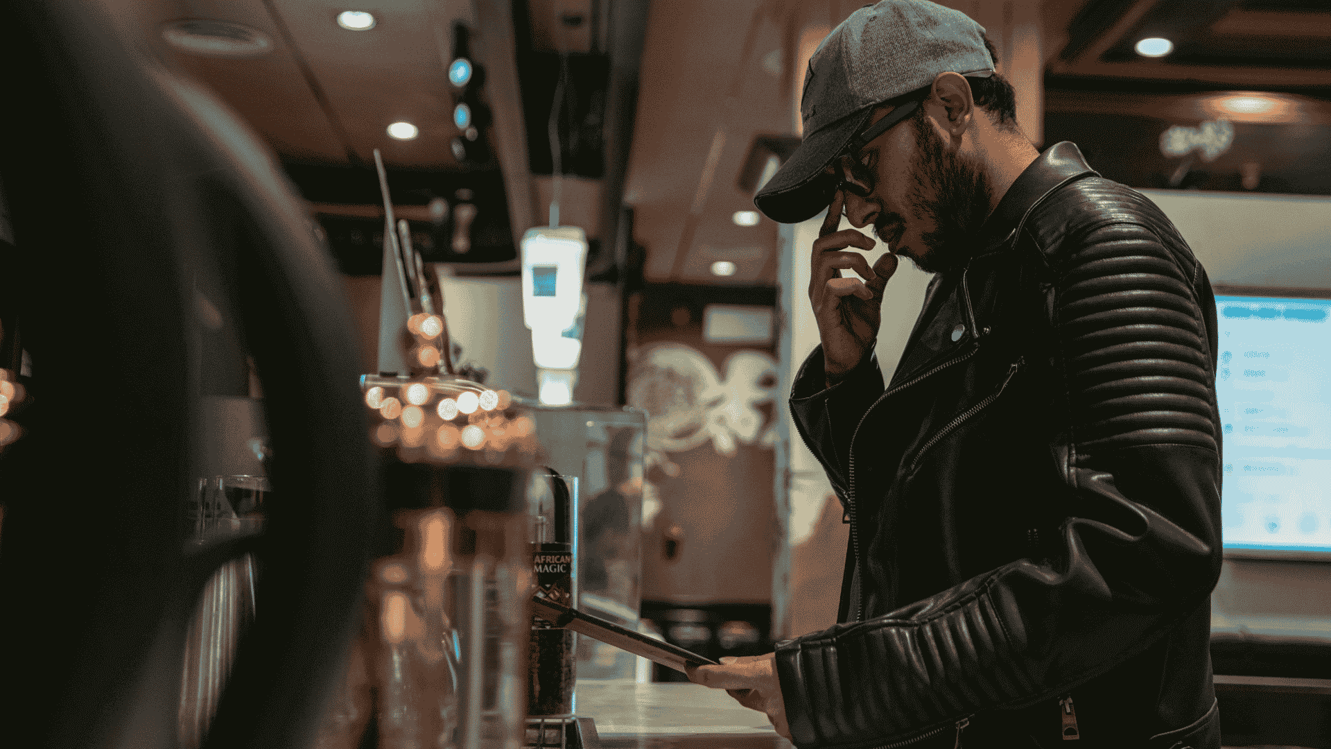 A man ponders the order menu at a local cafe