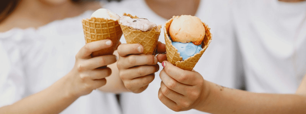 Three children holding ice cream cones