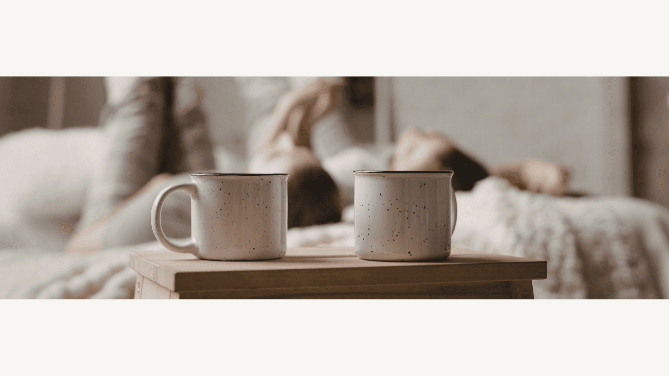 A restaurant interior featuring marble countertops, brown leather chairs, wood-paneled walls, and round pendant lights hanging above a bar set with wine glasses.