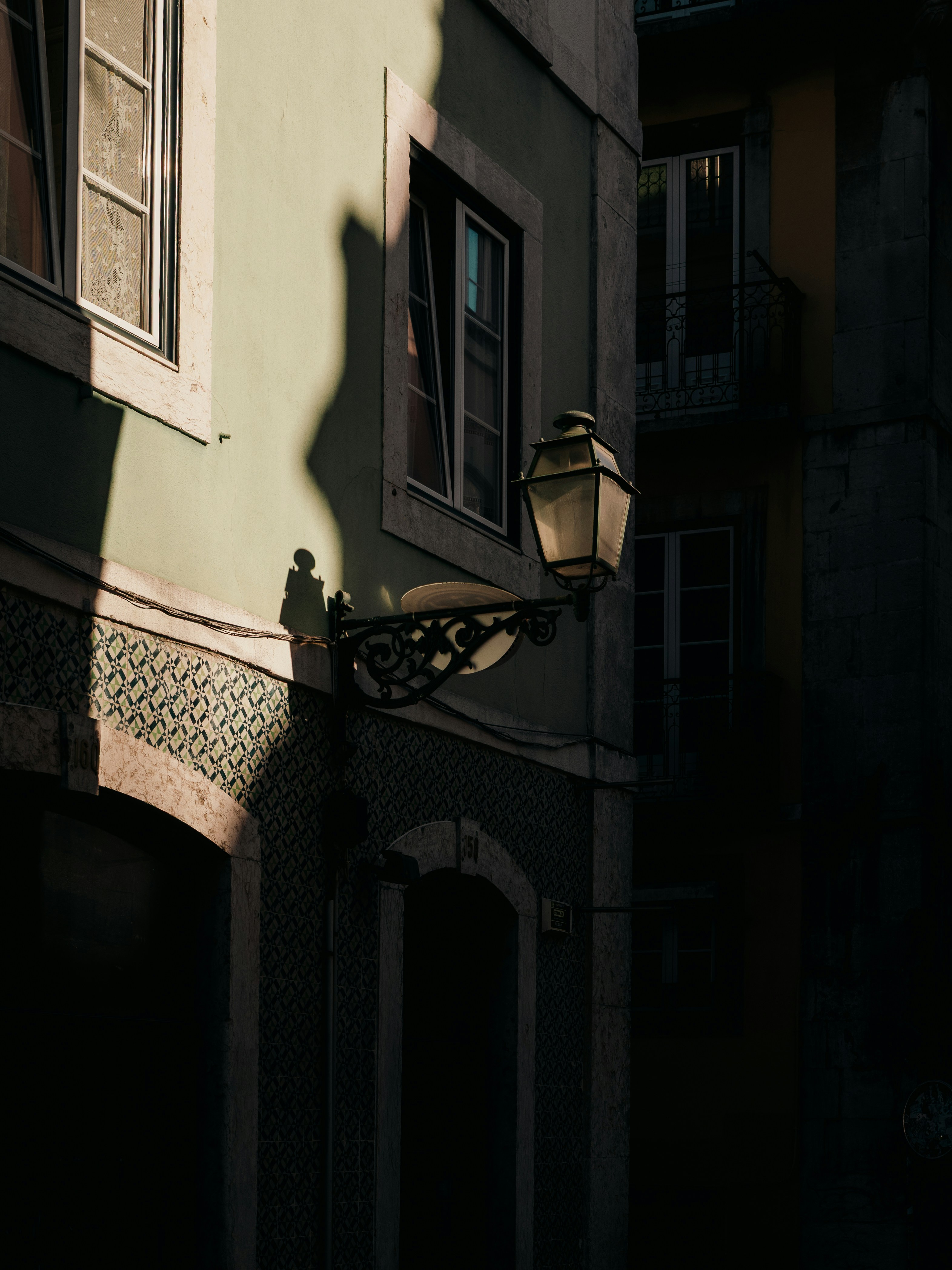 Old street lamp on a building facade