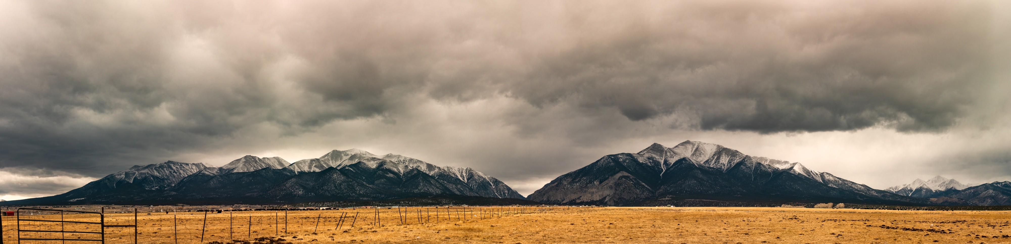 Panoramic landscape photograph of mountains, water, desert, or coast by Lucas Jensen