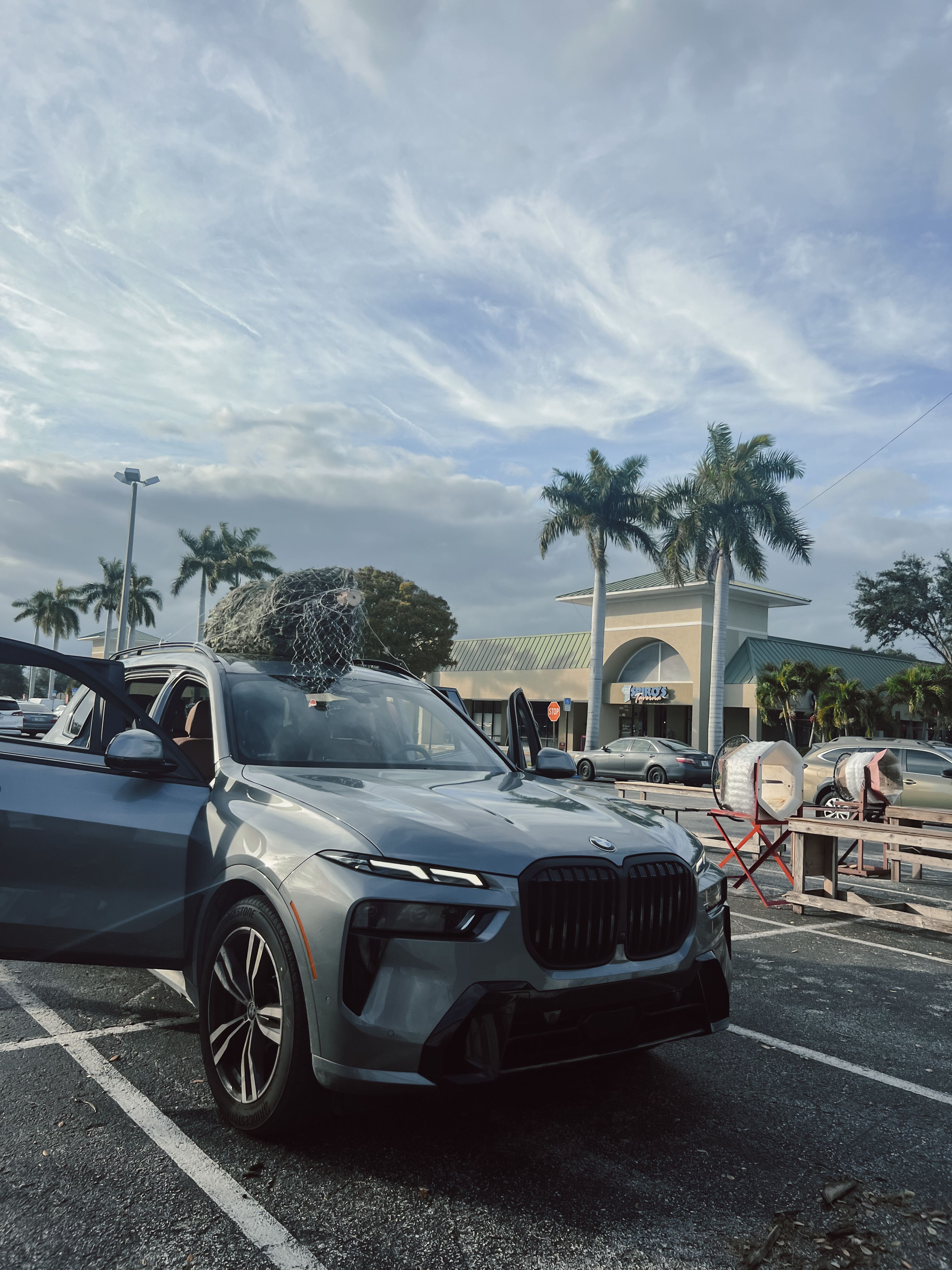 hodge podge customer's vehicle with christmas tree strapped ontop