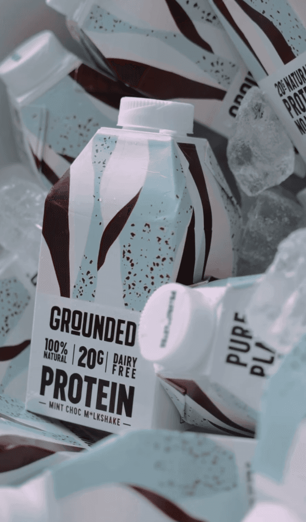Grounded 100% natural plant-based protein powder packaging showing clean ingredients