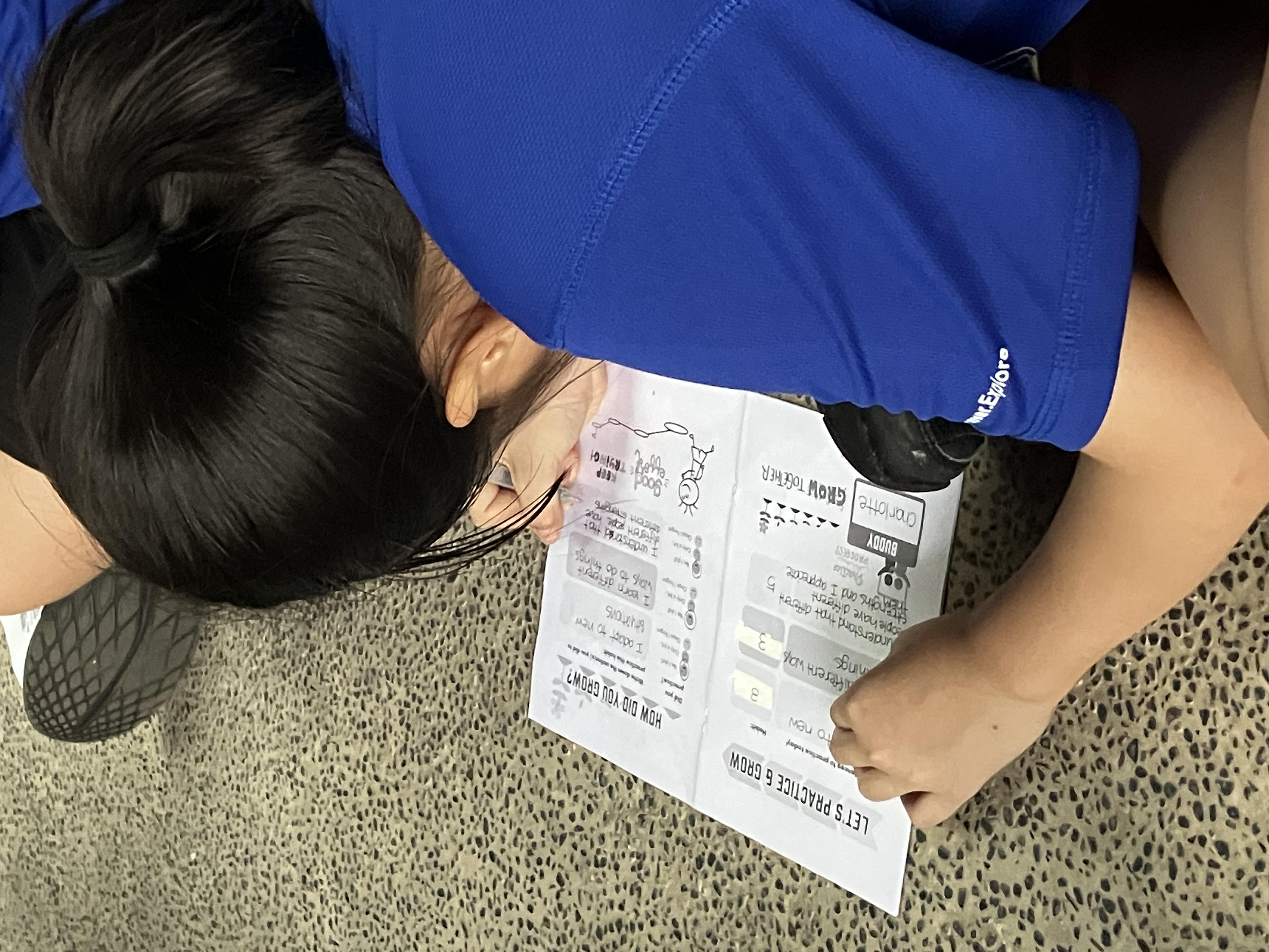 Close-up of a dark green leaf showing its textured surface and central vein against a muted background.